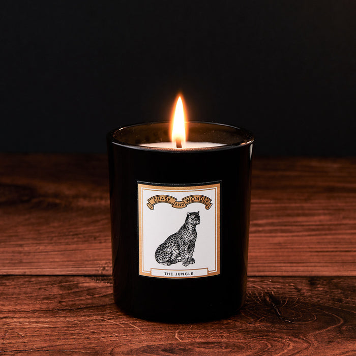 The Jungle Luxury Scented Glass Candle by Chase and Wonder, elegant black glass vessel with gold lid