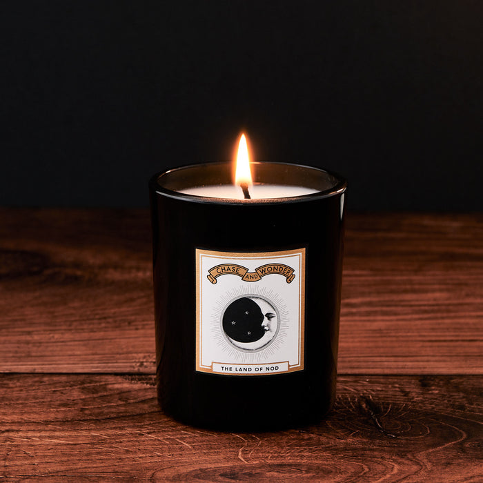 The Land of Nod Luxury Glass Candle by Chase and Wonder, elegant black glass vessel with gold lid