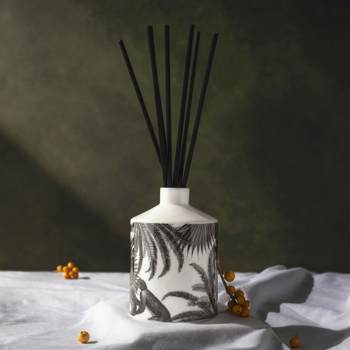 The Tropical Paradise ceramic reed diffuser, close-up of the hand-decorated illustration and 22ct gold