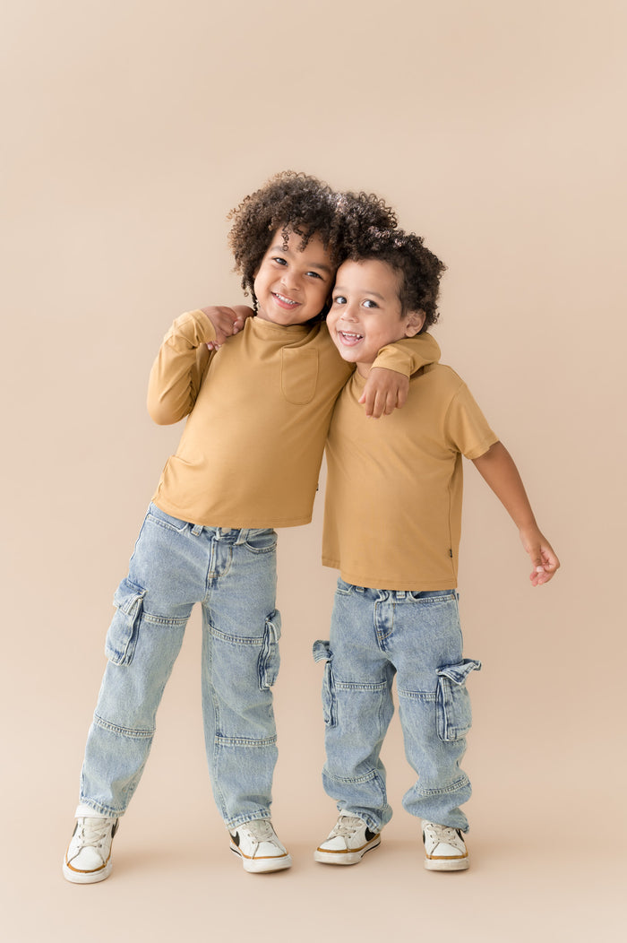 Two boys hugging in short sleeve and long sleeve basic tee in ochre