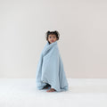 Standing toddler wrapped in Toddler Blanket in Fog 1.0