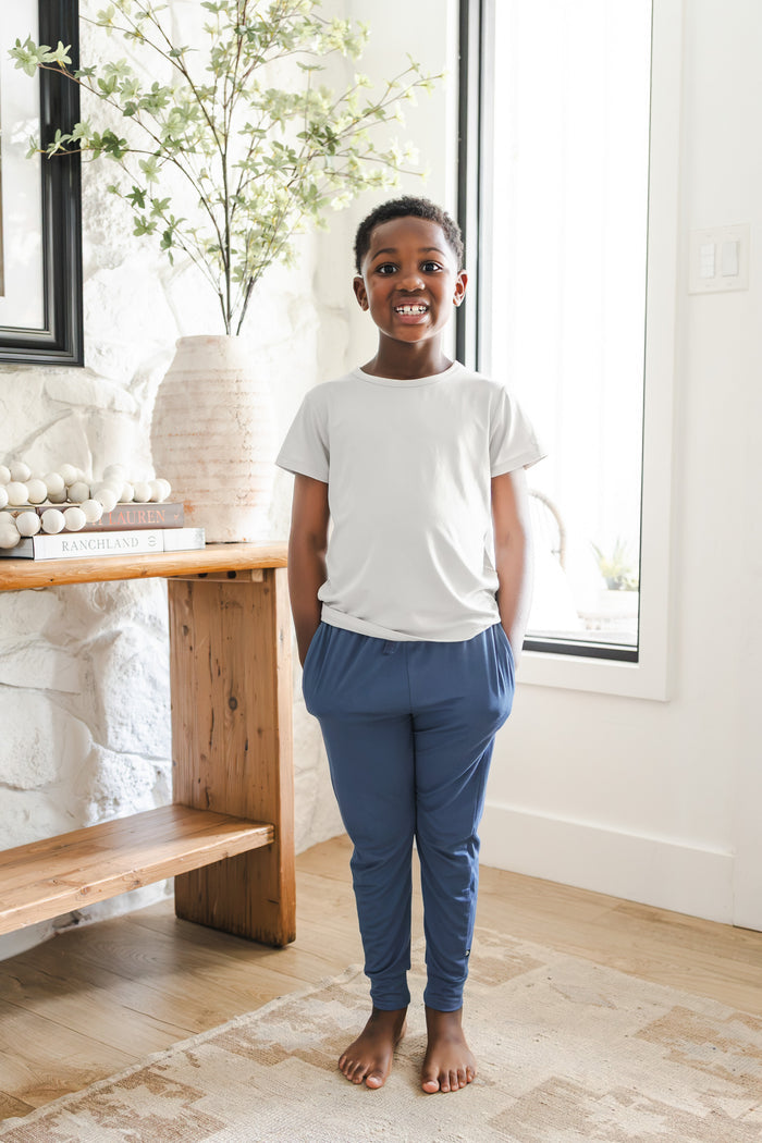 Toddler wearing Toddler Jogger Pant in Oxford under white shirt standing in a room
