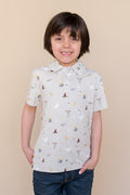 Child wearing a short-sleeve polo shirt with Harry Potter prints on a beige background