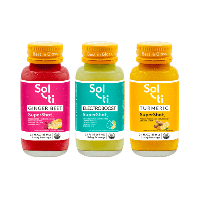 Three Sol-ti SuperShot glass bottles: GINGER BEET, ELECTROBOOST, and TURMERIC