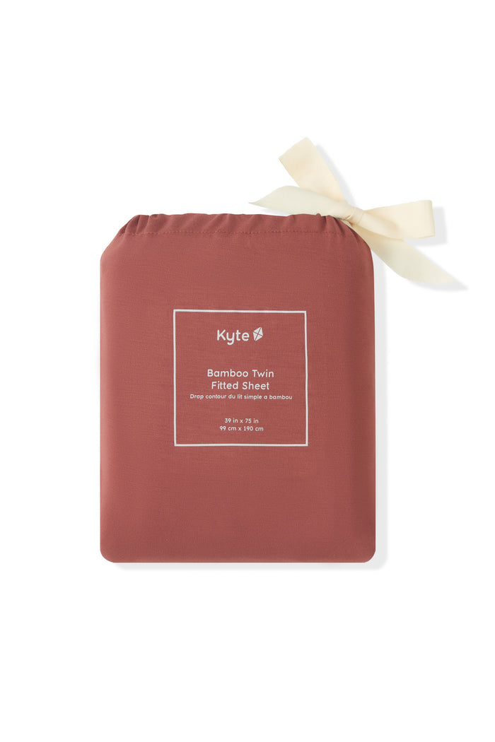 Twin Sheet in Ember packed in a burgundy bag on a white background