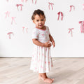 Little girl modeling Twirl Dress in Bow