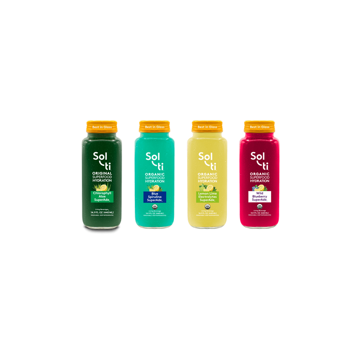 Four glass SuperAde bottles: Chlorophyll Aloe, Blue Spirulina, Lemon Lime & Wild Blueberry
