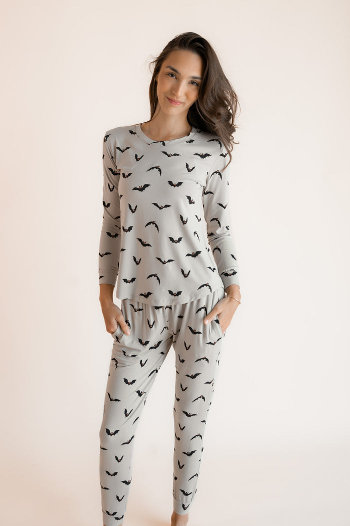Modal posing in Women's Jogger Pajama Set in Bats print on a white background