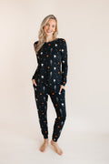 Modal wearing Women's Jogger Pajama Set in Halloween Friends print on a beige background