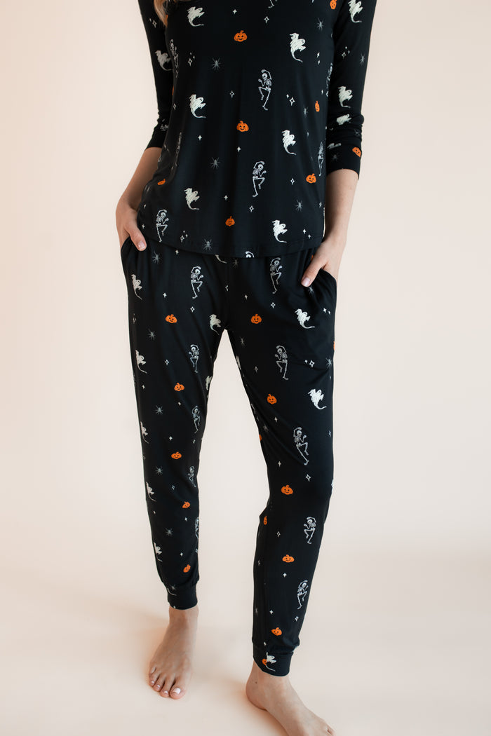 Close up of Modal wearing Women's Jogger Pajama Set in Halloween Friends print on a beige background