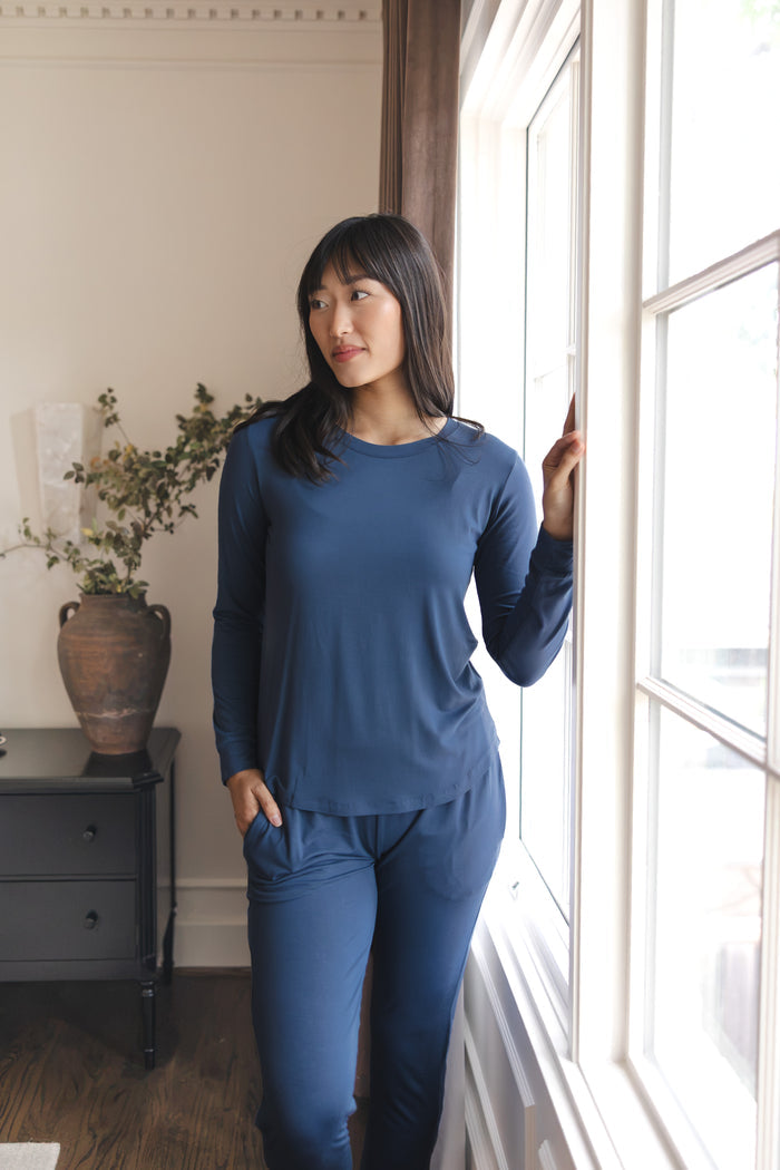 Modal posing in Women's Jogger Pajama Set in Oxford standing near a glass window