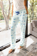 woman wearing pink pajama pants with a mahjong tile pattern