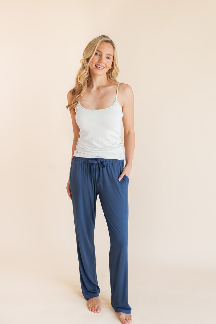 Model smiling in Women's Lounge Pants in Oxford under a white camisole on a beige background