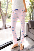 woman wearing pink pajama pants with a mahjong tile pattern