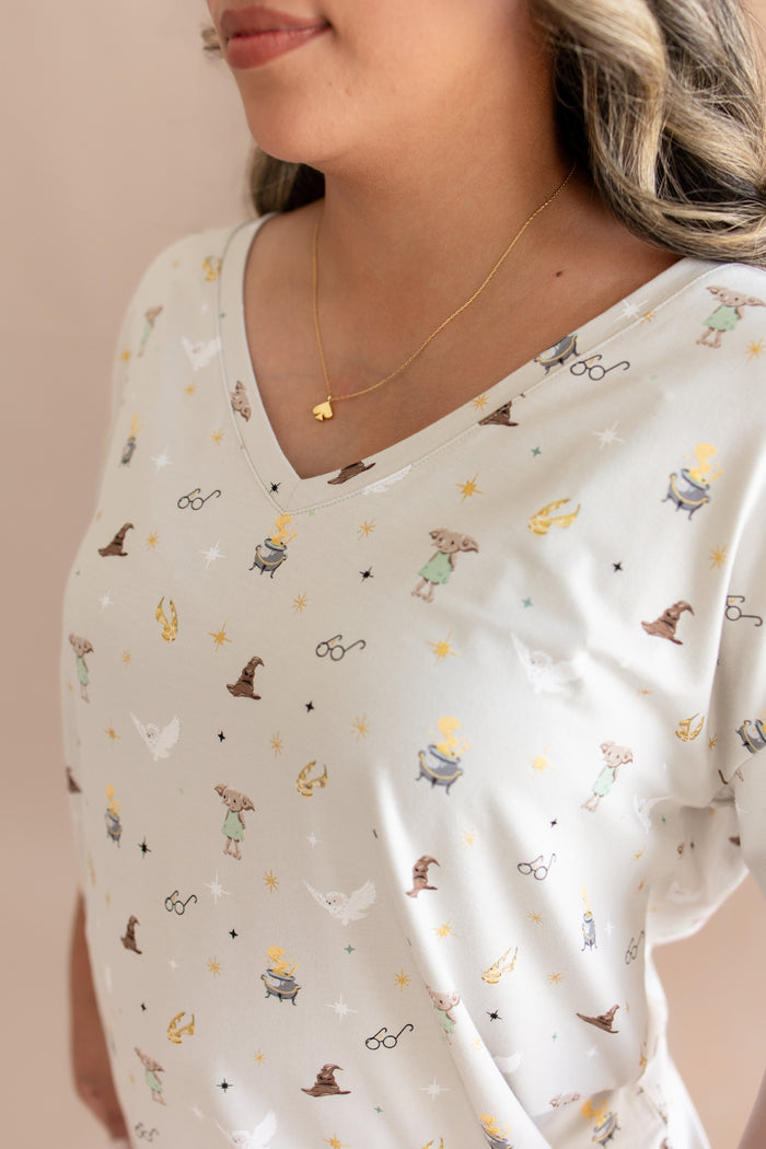 Neck of model wearing Women's Relaxed Fit V-Neck with Harry Potter prints on a beige background