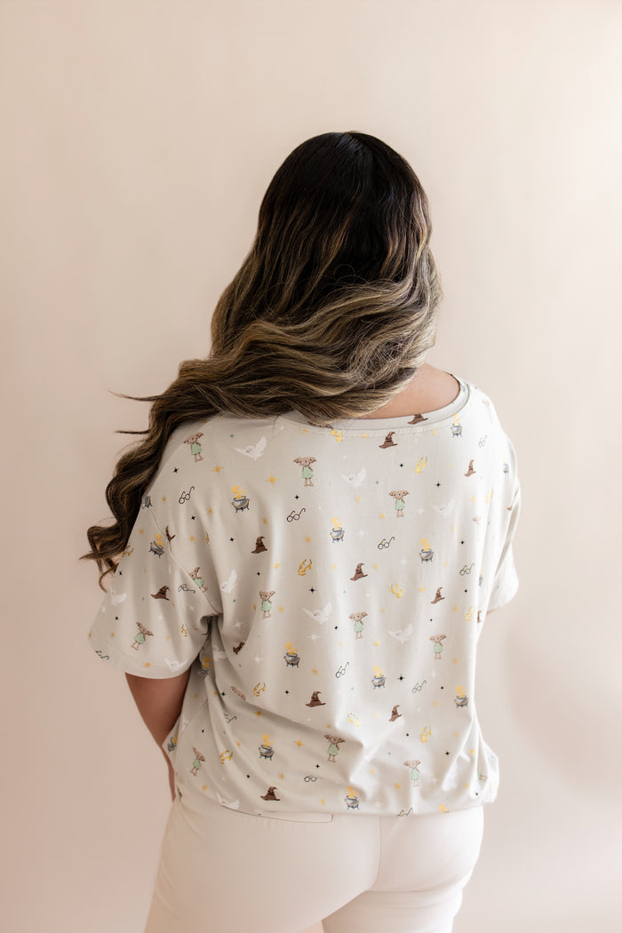 Back side of Women's Relaxed Fit V-Neck with Harry Potter prints on a beige background