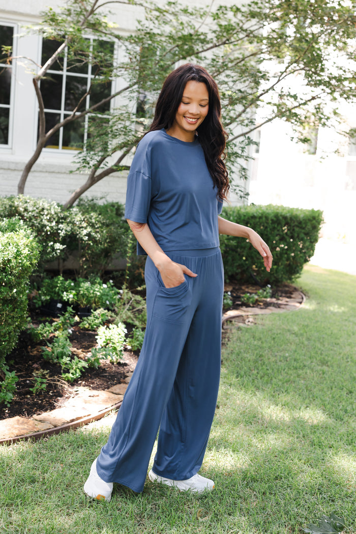 Modal smiling in Women's Wide Leg Pant in Oxford standing outdoors in a garden