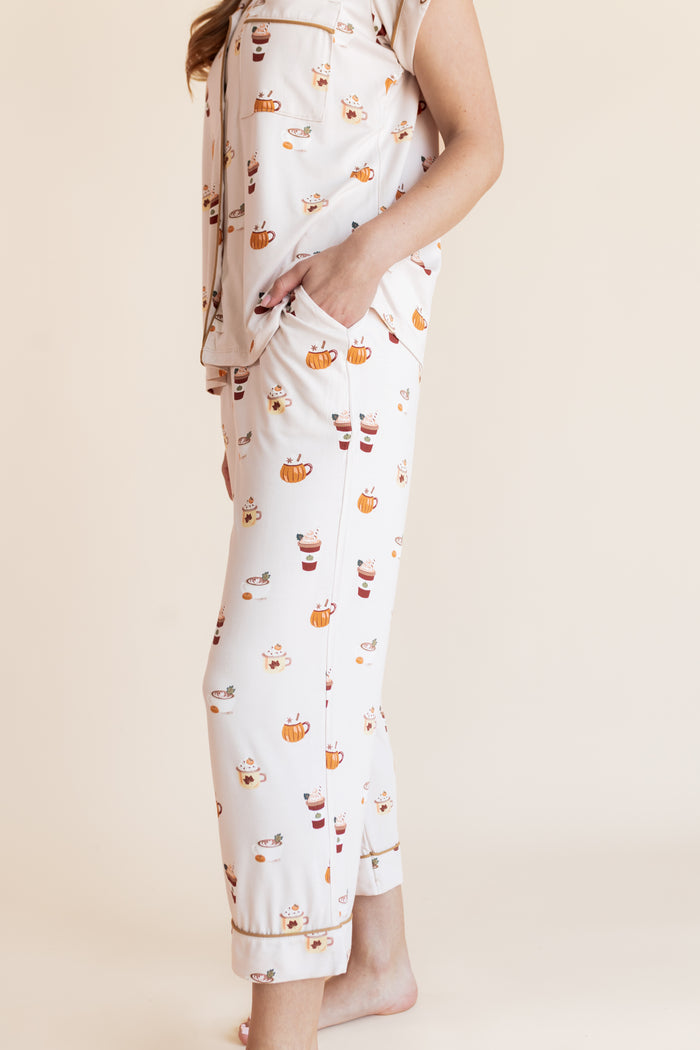 Modal showcasing the pajama pockets  on Women's Short Sleeve Cropped Pajama Set with Pumpkin Spice Latte print on a beige background