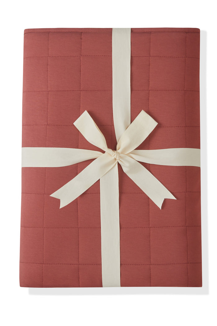 Youth Blanket in Ember 2.5 packed in ribbon on a white background