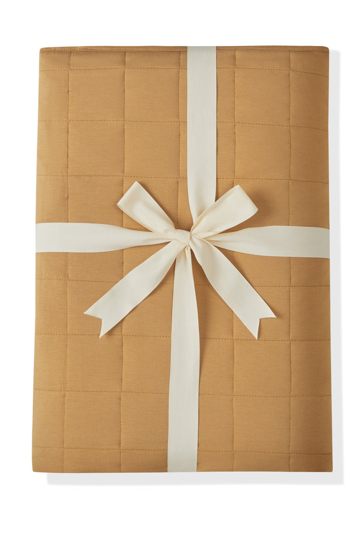 Youth Blanket in Ochre 2.5 packed in a ribbon on a white background