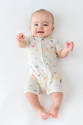 Baby wearing a pastel mickey head patterned shortall romper
