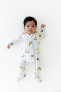 Newborn laying on a white surface wearing the Zippered Footie in Amalfi Coast