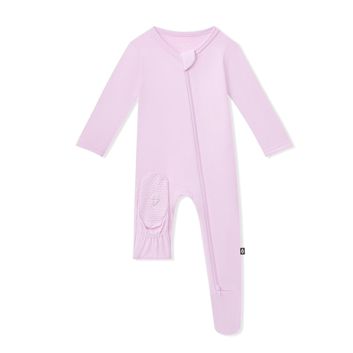 Purple baby footie with sole grips on the foot a white background